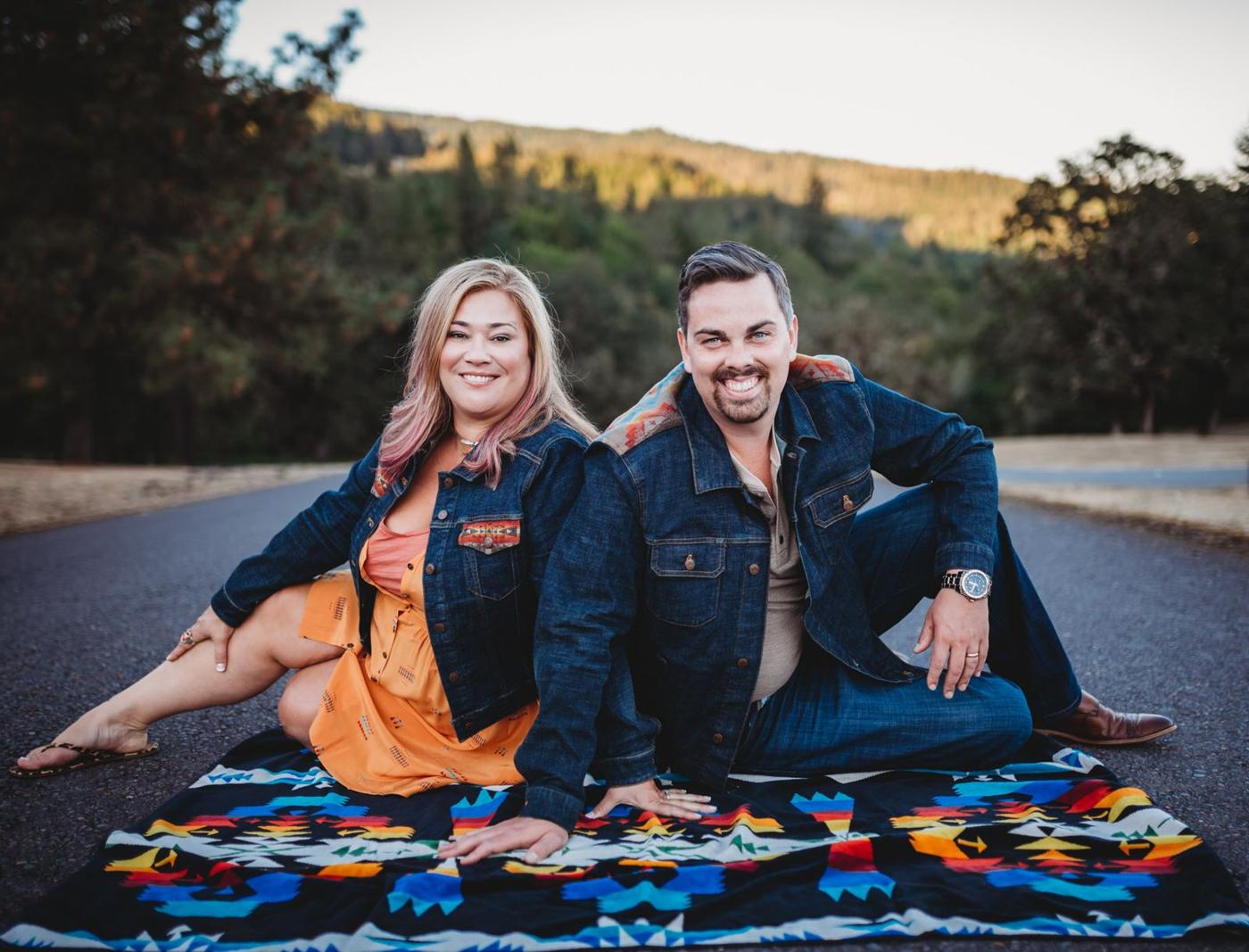 Geoff and Kathryn Belleville sitting together outdoors in the Oregon hills