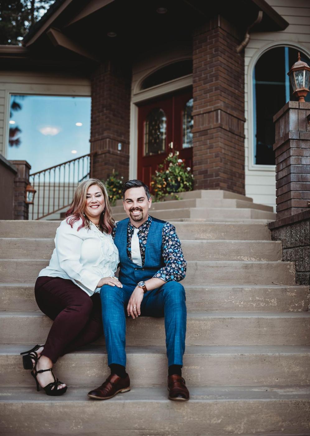 Geoff and Kathryn sitting on the front steps of their home
